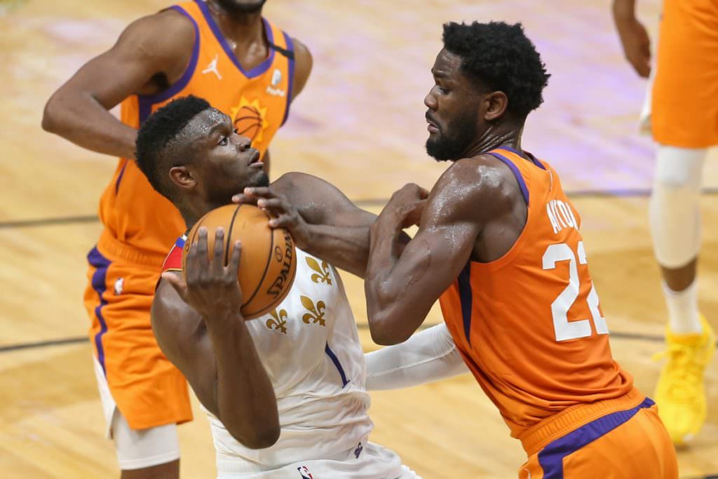 Pelicans forward Zion Williamson (1) is defended by Phoenix Suns center Deandre Ayton (22)