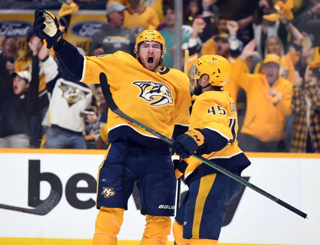 May 9, 2022; Nashville, Tennessee, USA; Nashville Predators center Yakov Trenin (13) celebrates with defenseman Alexandre Carrier (45) after scoring during the second period against the Colorado Avalanche in game four of the first round of the 2022 Stanley Cup Playoffs at Bridgestone Arena. Mandatory Credit: Christopher Hanewinckel-USA TODAY Sports