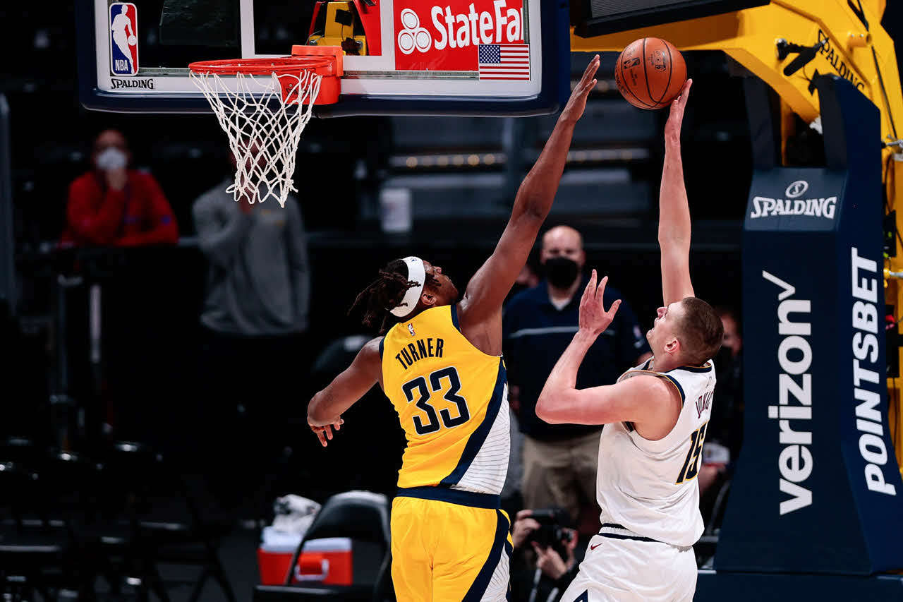 Denver Nuggets center Nikola Jokic (15) drives to the net against Indiana Pacers guard Malcolm Brogdon (7)