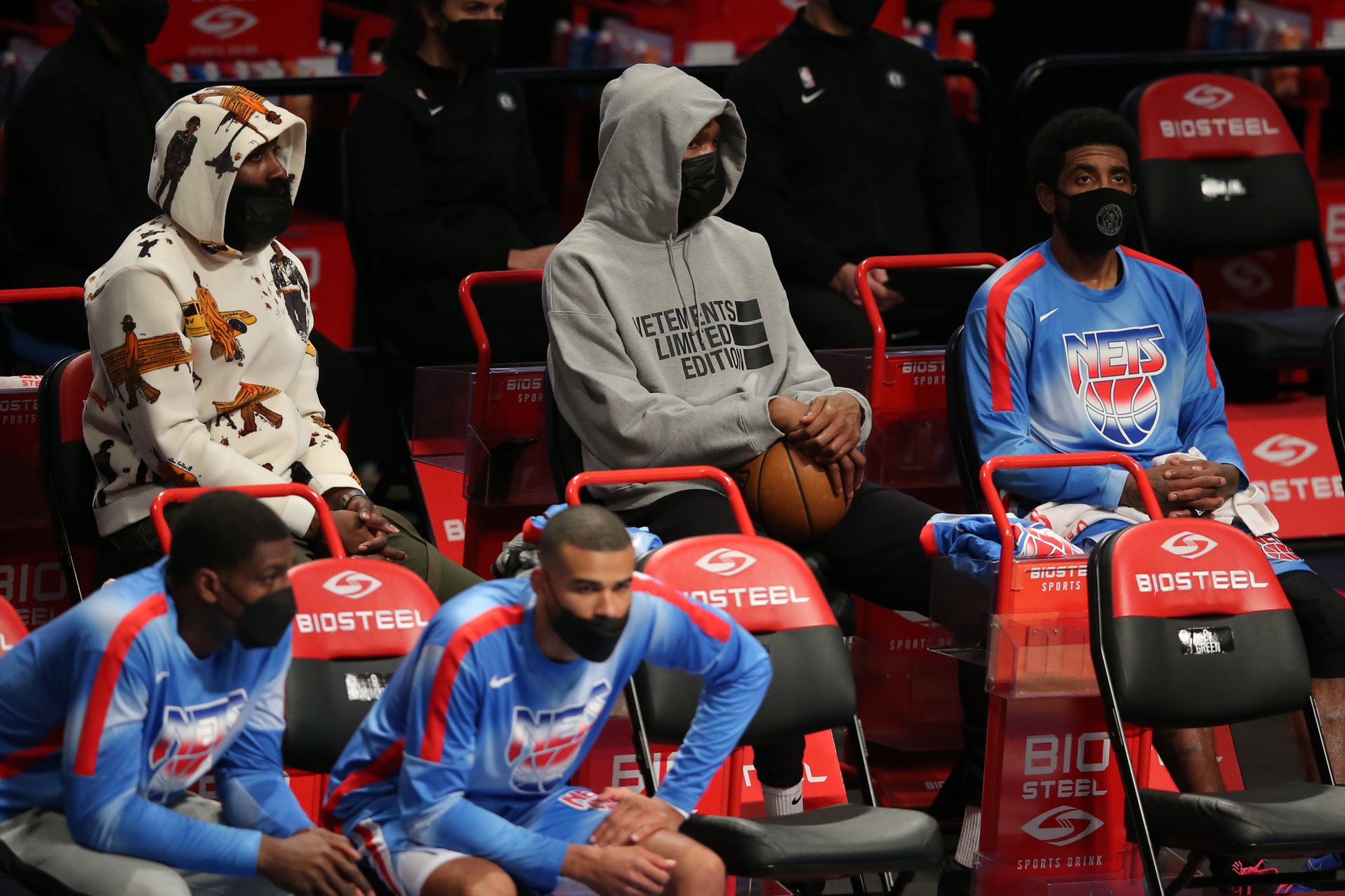 Brooklyn Nets shooting guard James Harden (left to right) and power forward Kevin Durant (7) and point guard Kyrie Irving (11) sit on the bench