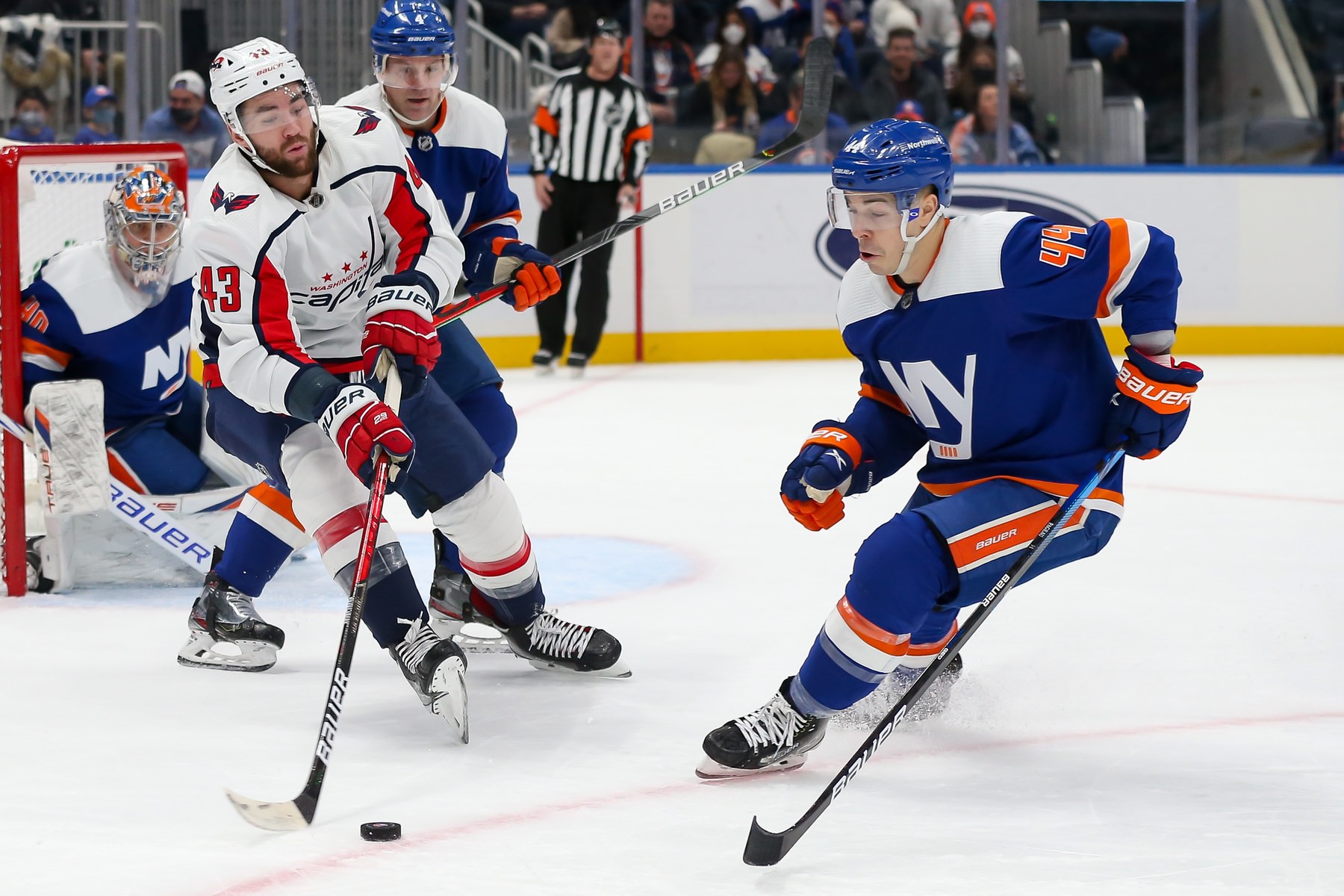 Washington Capitals right wing Tom Wilson (43) moves the puck past New York Islanders center Jean-Gabriel Pageau (44)