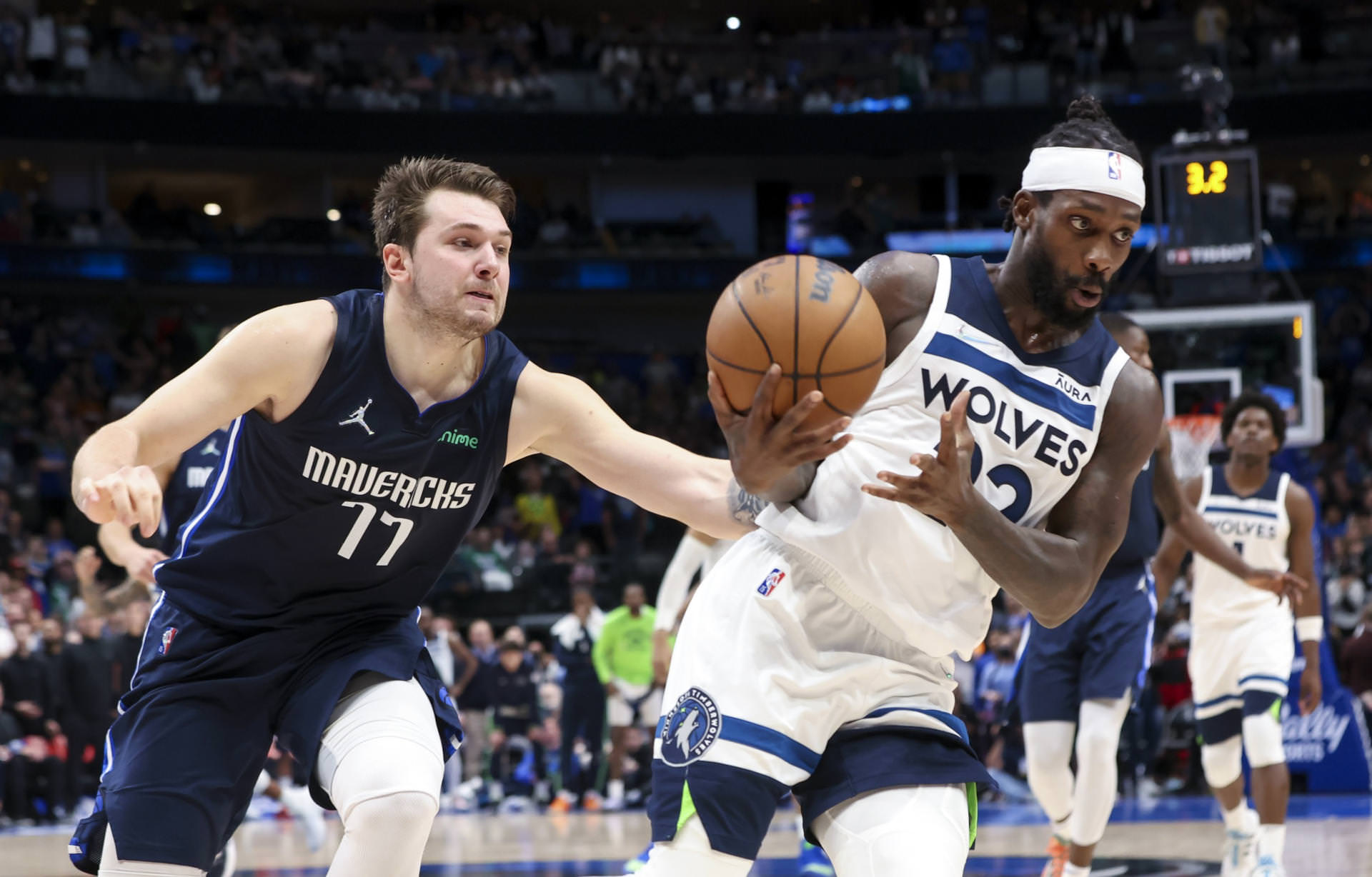 Dallas Mavericks guard Luka Doncic (77) fouls Minnesota Timberwolves guard Patrick Beverley (22) during the fourth quarter at American Airlines Center.
